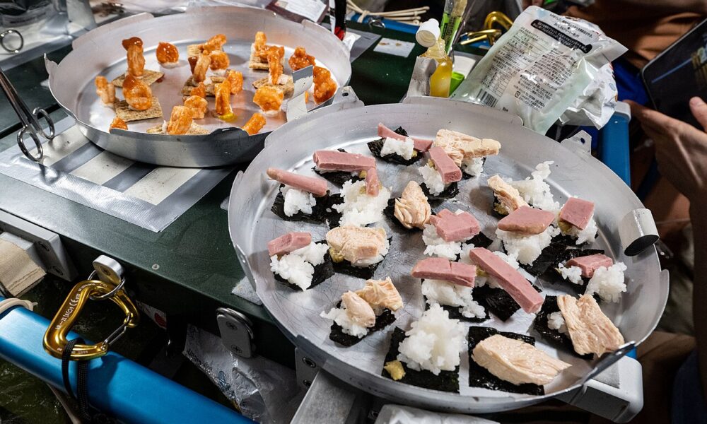 Real space food on two trays aboard the ISS: sushi, shrimp and crackers photographed by NASA, August 2025