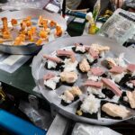 Real space food on two trays aboard the ISS: sushi, shrimp and crackers photographed by NASA, August 2025