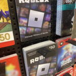 Actual Roblox gift card products on a rack at a retail store
