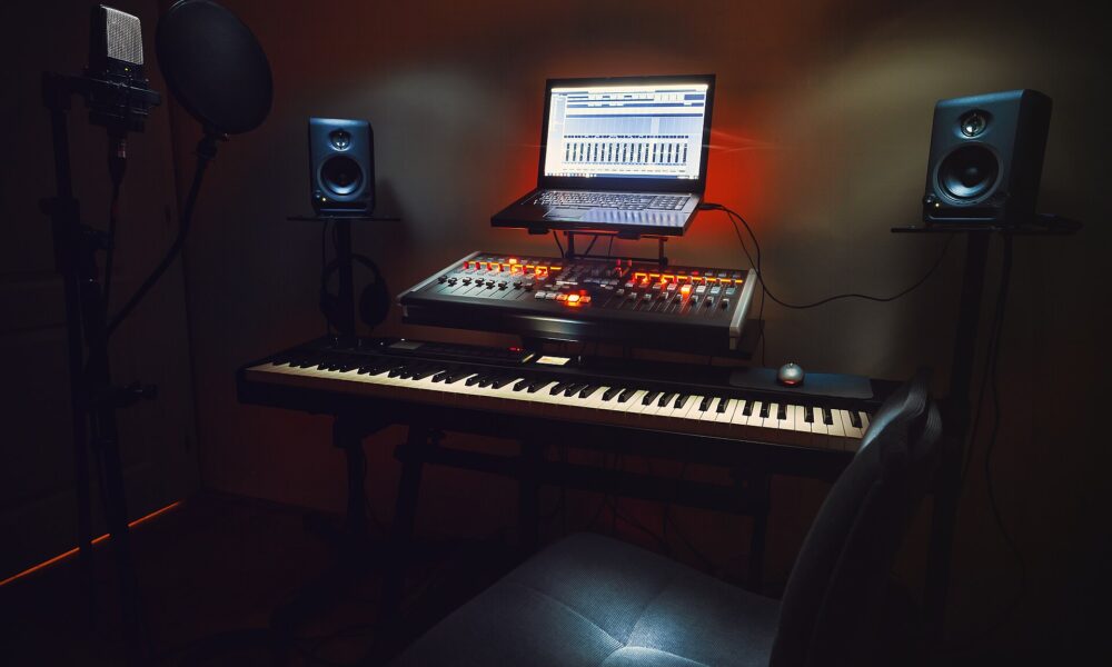 Real home audio recording studio with microphone and laptop