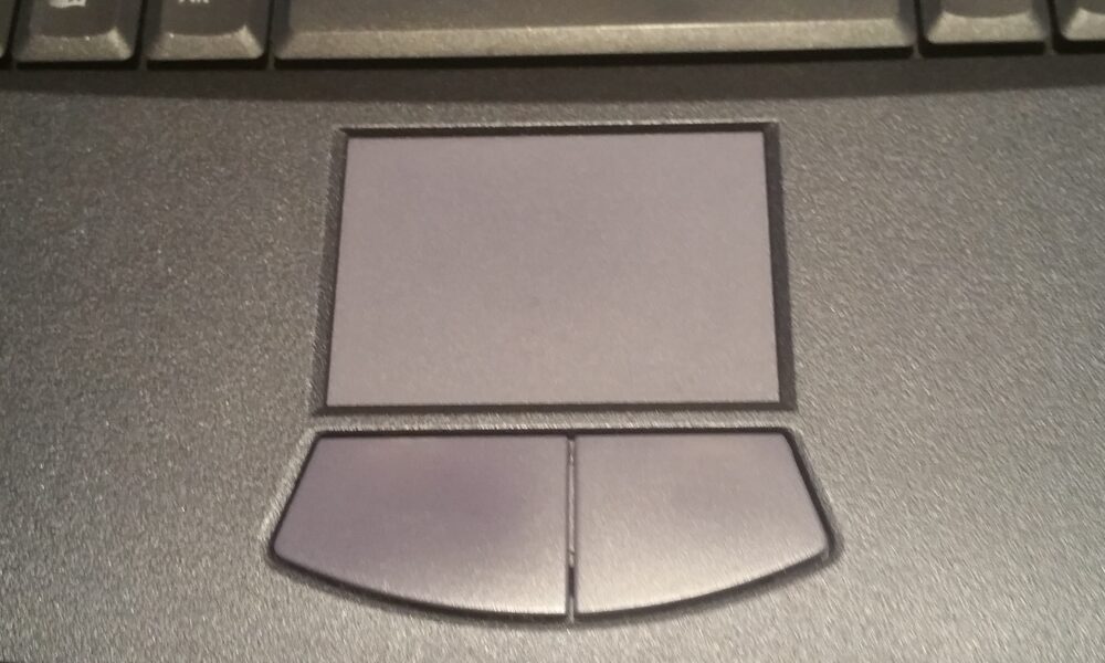 Physical touchpad below a laptop keyboard, used for pointing and camera control in Roblox without an external mouse