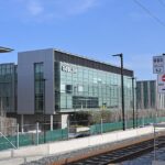 Real photograph of Roblox building in San Mateo, seen from nearby transit tracks