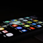 Close-up photograph of a Samsung Galaxy phone displaying its home screen with app icons