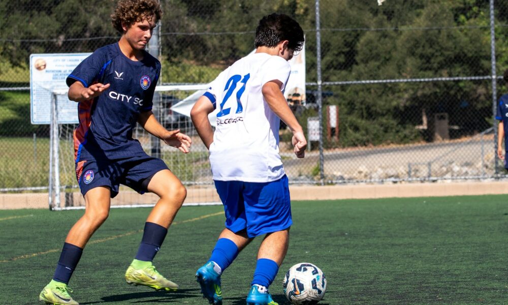 Young soccer players practicing a defensive challenge for the ball