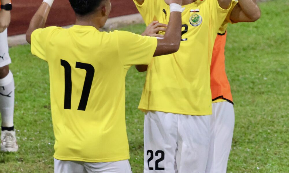 Football player celebrating a goal during a match, used to illustrate a brace in soccer