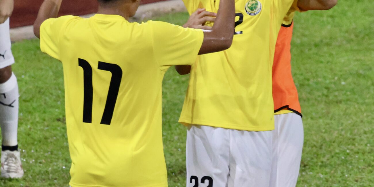 Football player celebrating a goal during a match, used to illustrate a brace in soccer