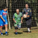 Soccer goalkeeper reaching to catch a ball near the goal during a match