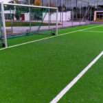 Football field with center area and goal, illustrating where a soccer kick-off begins