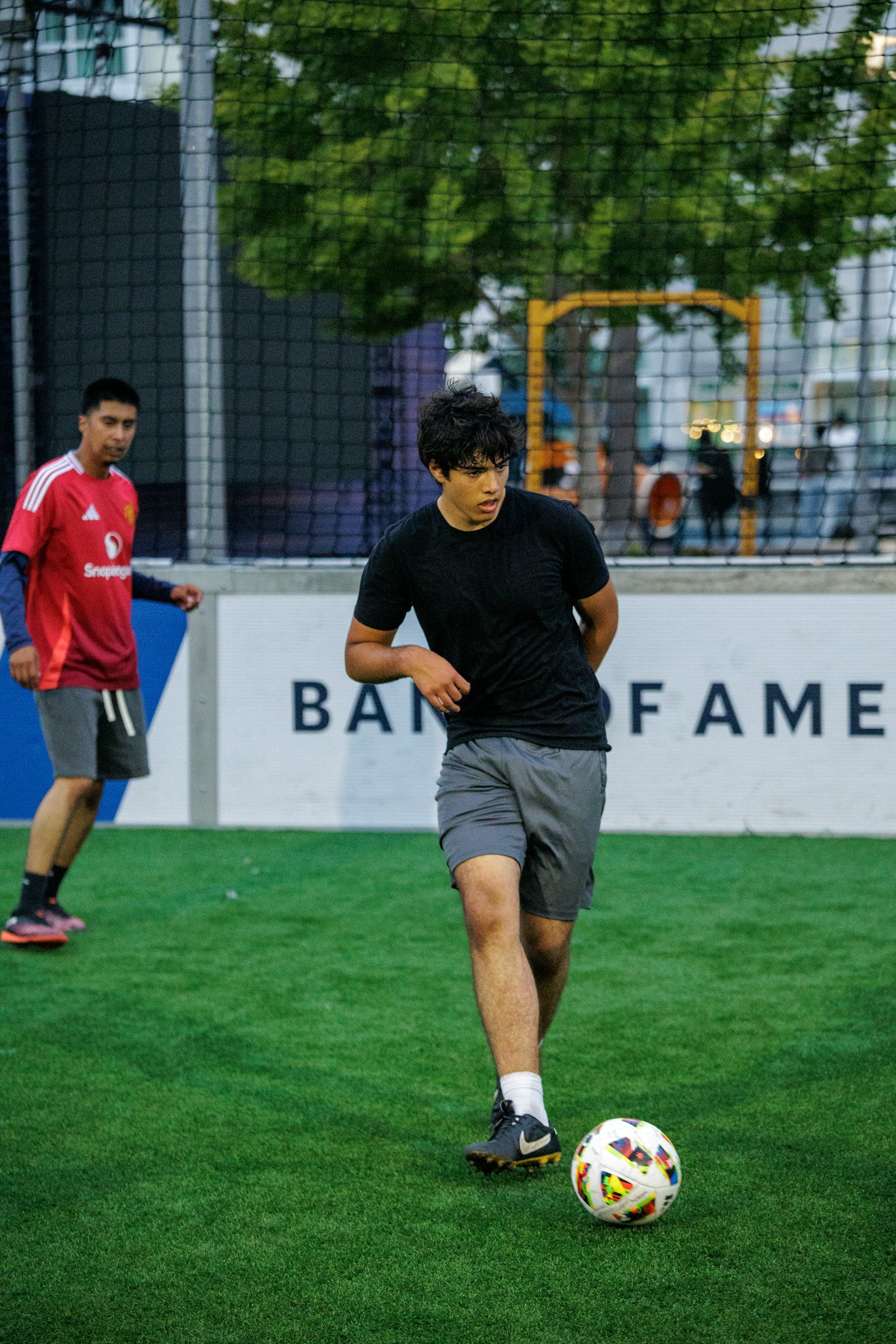 Soccer player practicing close ball control on an artificial turf field