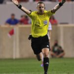Referee Mark Geiger signaling advantage during an MLS soccer game