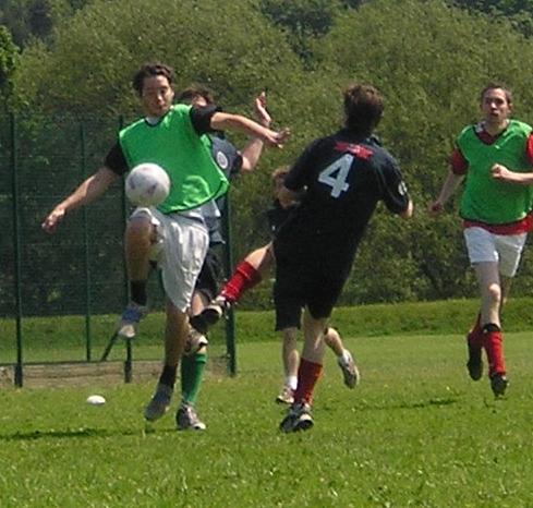 Two soccer players contesting the ball illustrating tackles, fouls and IFAB Law 12