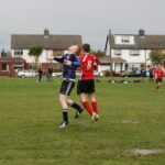 Two soccer players jump for a headed ball in Beechlawn Rovers versus Boardeaux match