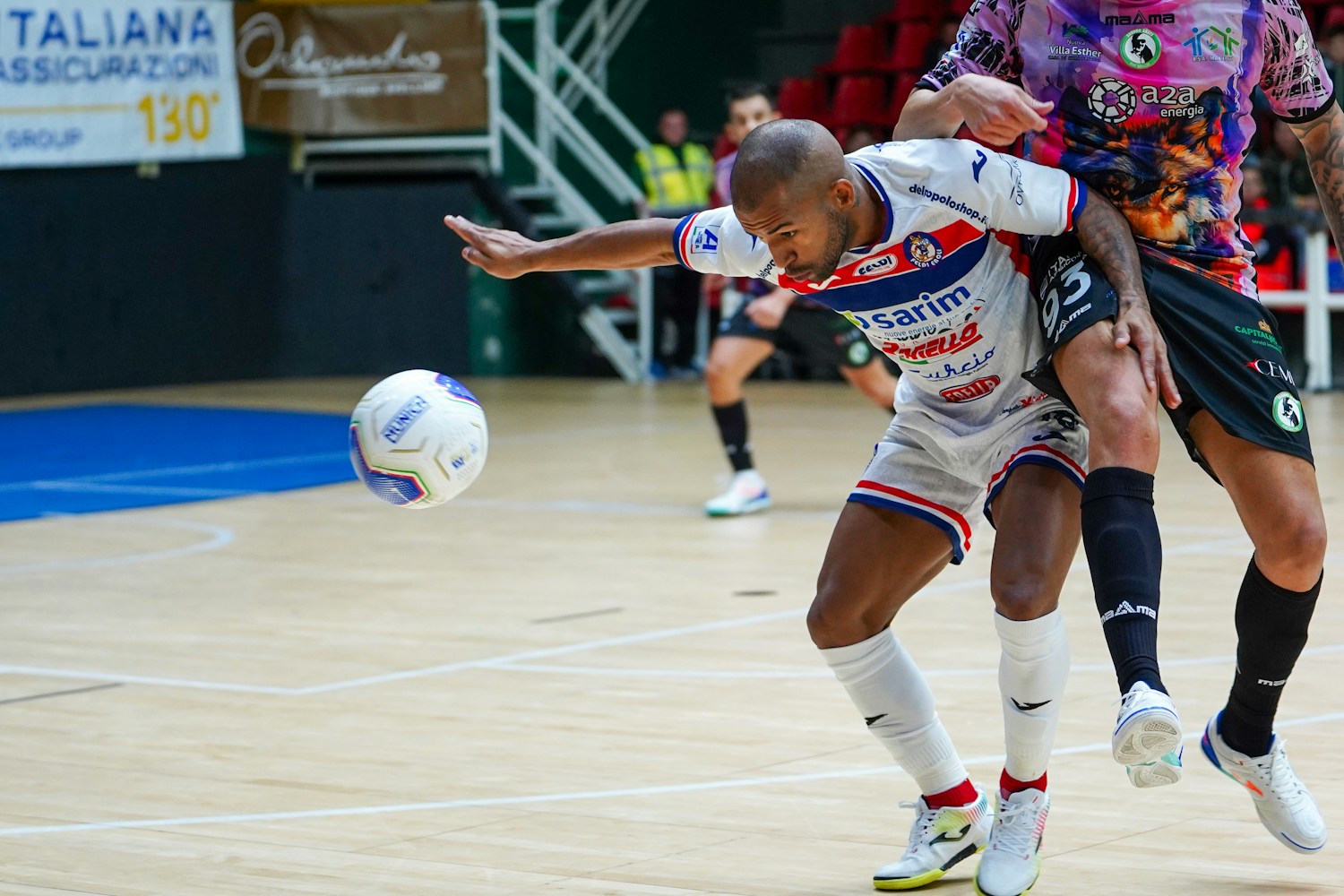 Two soccer players competing for the ball during a defensive challenge