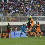 Soccer players in match action during Cameroon versus Ivory Coast, illustrating passing and movement