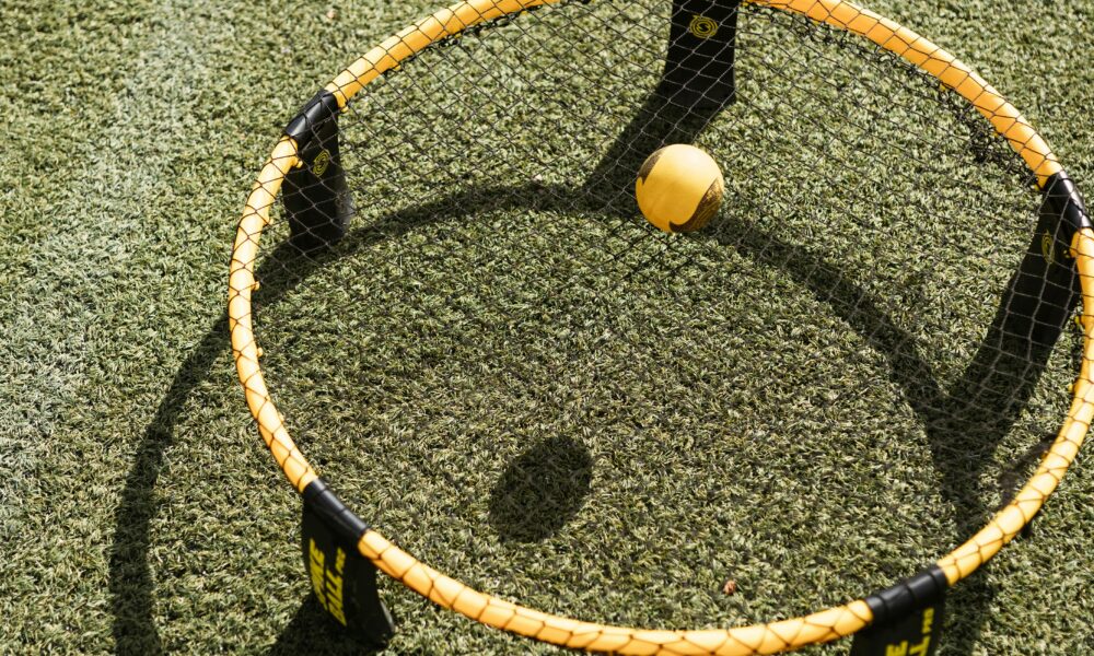 Real Spikeball roundnet set with a yellow ball resting in a circular outdoor net