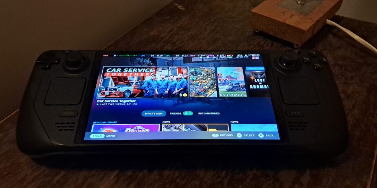 Real photograph of a Steam Deck OLED handheld console showing its display and controls