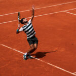 Carlos Alcaraz serving a tennis ball at Roland Garros, illustrating how an ace begins