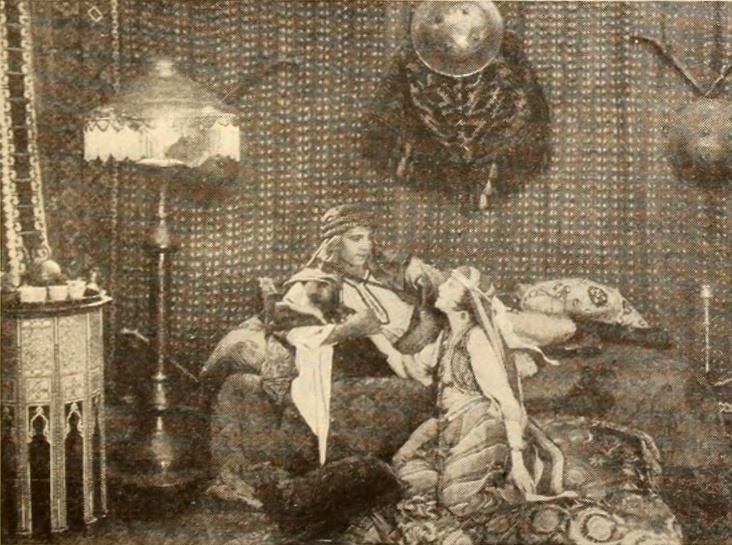 Historical Photoplay still from 1921 The Sheik showing Rudolph Valentino and Agnes Ayres seated in the desert tent interior