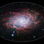 NASA Spitzer infrared view of the Triangulum Galaxy M33 showing spiral arms and star-forming dust regions
