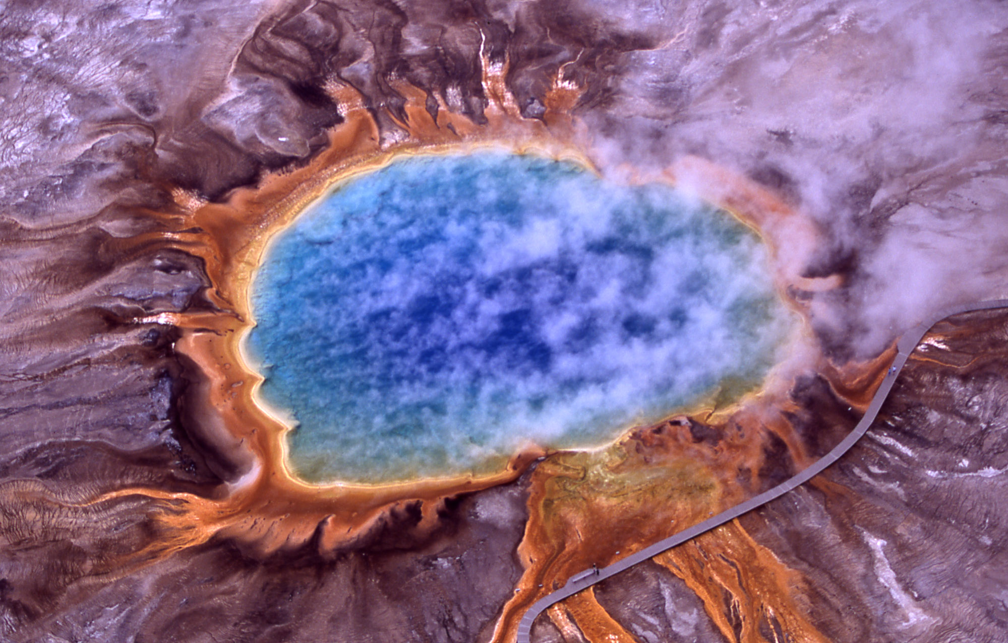 Genuine National Park Service Jim Peaco aerial photograph of Yellowstone Grand Prismatic Spring with blue hot water orange microbial rings and steam