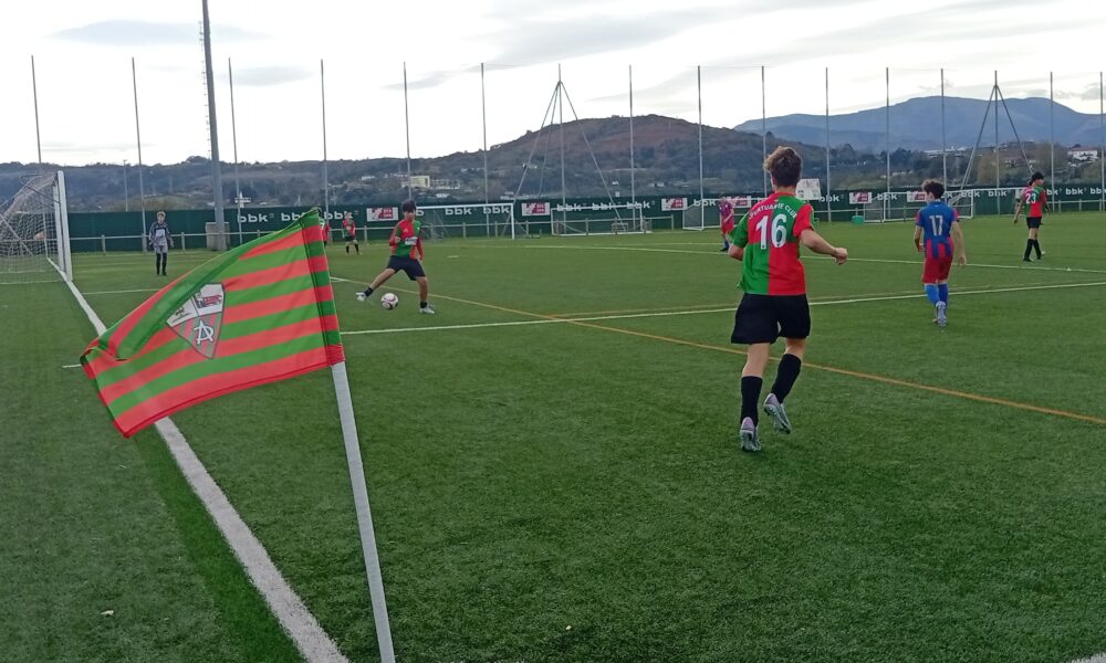 Youth soccer players during an Apurtuarte versus Lagun Artea match on a marked football pitch