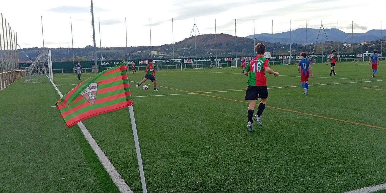Youth soccer players during an Apurtuarte versus Lagun Artea match on a marked football pitch