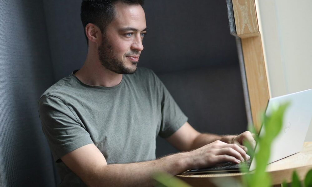 Startup founder working on a laptop for the Claude Startups program guide