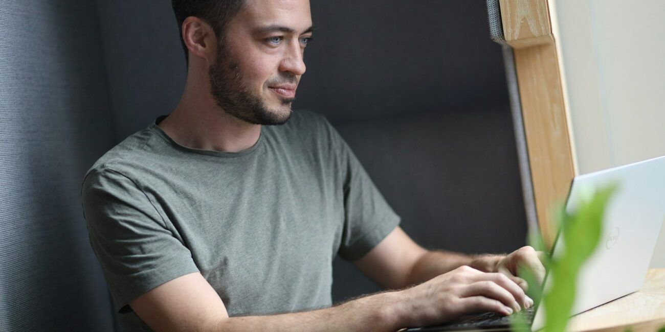 Startup founder working on a laptop for the Claude Startups program guide