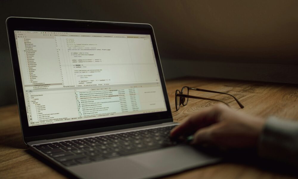 Developer using a laptop with code for the DeepSeek Harness v0.2 guide