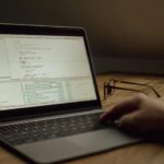 Developer using a laptop with code for the DeepSeek Harness v0.2 guide