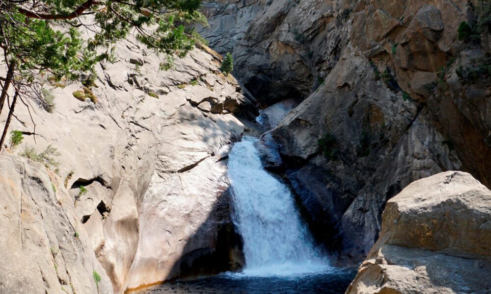 Real Roaring River Falls in Kings Canyon National Park, a waterfall crashing through granite cliffs into a pool near Cedar Grove, California