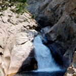 Real Roaring River Falls in Kings Canyon National Park, a waterfall crashing through granite cliffs into a pool near Cedar Grove, California