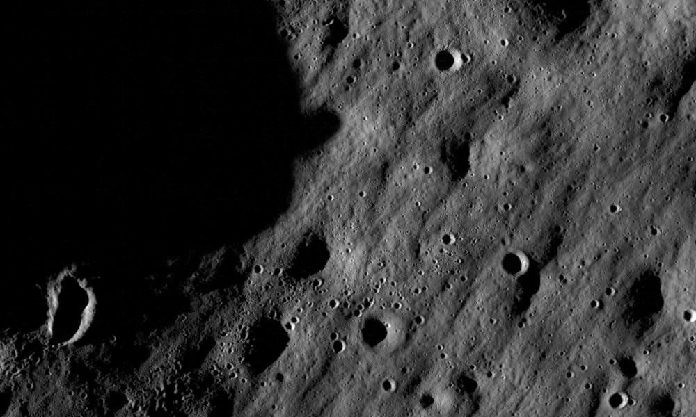 Actual Moon surface image with small impact craters recorded by NASA Lunar Reconnaissance Orbiter Narrow Angle Camera