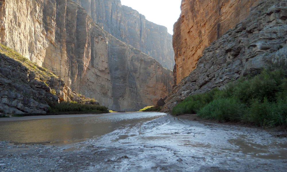 The actual Santa Elena Canyon in Big Bend National Park, limestone canyon walls rising above the Rio Grande near the riverside hiking trail.
