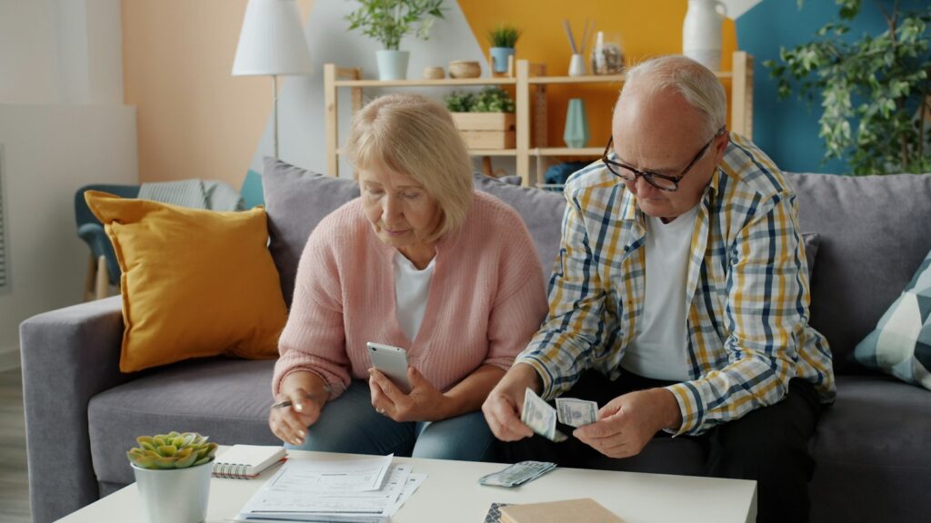 Older couple reviewing household finances for a Social Security COLA planning guide