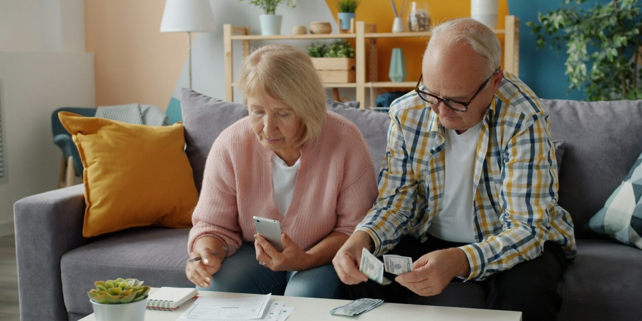 Older couple reviewing household finances for a Social Security COLA planning guide
