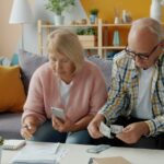 Older couple reviewing household finances for a Social Security COLA planning guide