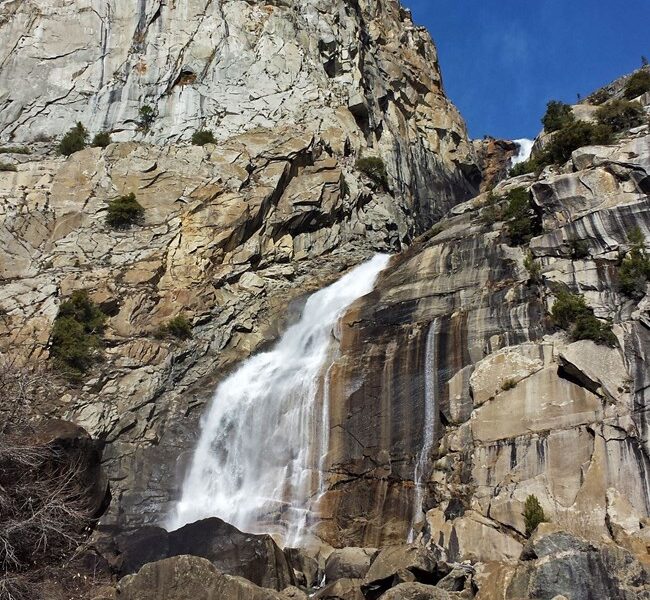 Real National Park Service photograph of Wapama Falls plunging down a granite cliff in Hetch Hetchy, Yosemite National Park